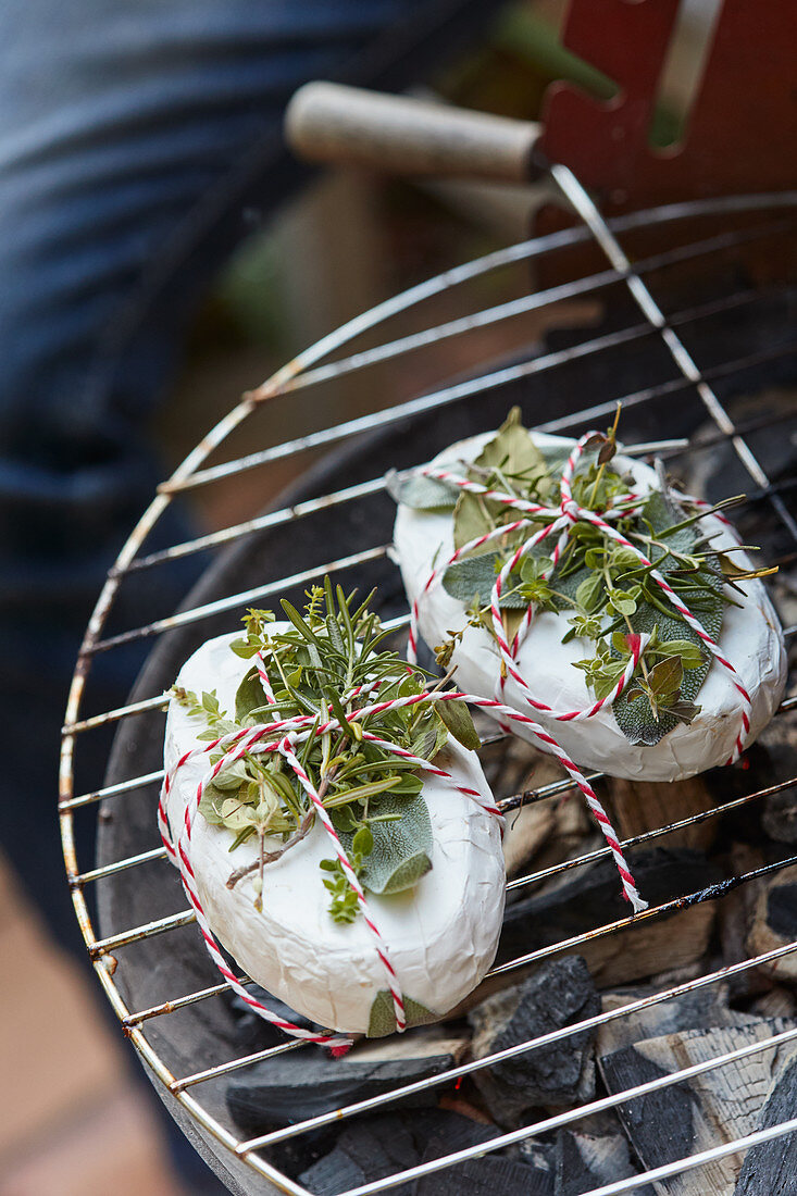 Camembert with fresh herbs on barbecue