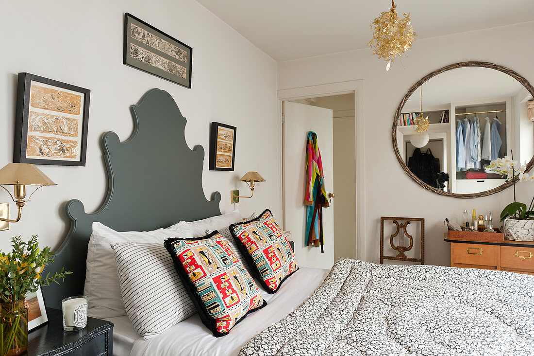 Bed with curved grey headboard in classic bedroom