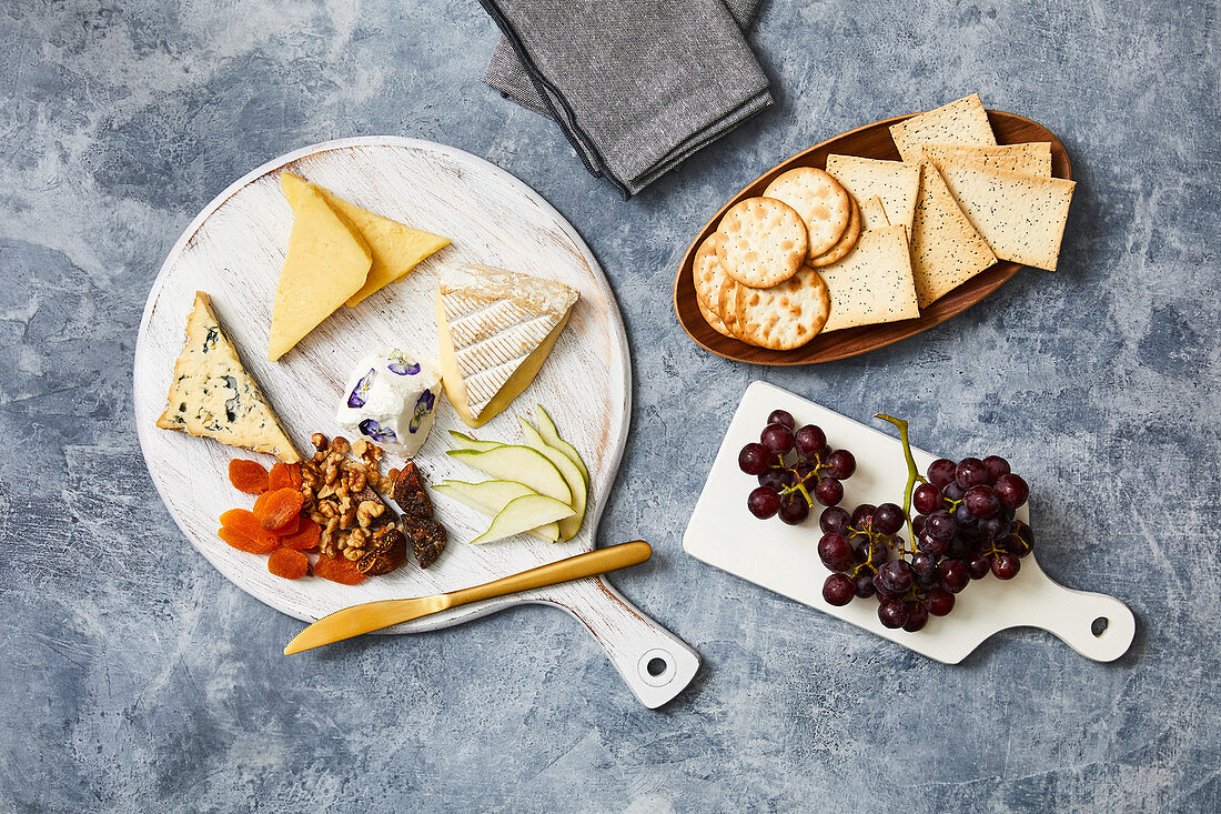Cheese board with crackers and grapes