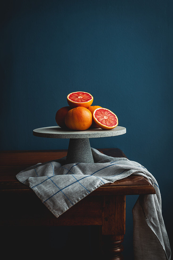 Pink grapefruits on a cake stand