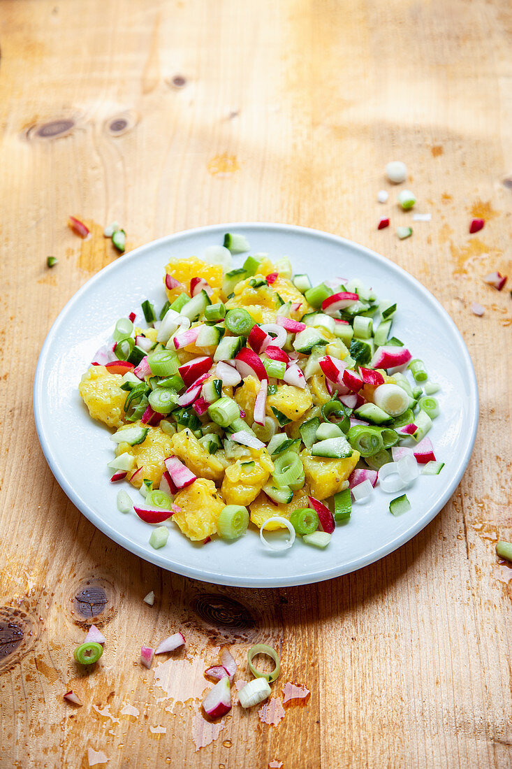 Potato salad with radishes, cucumbers and spring onions