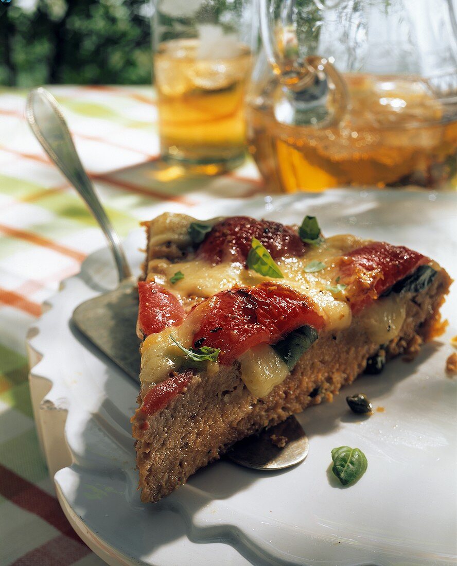 A piece of mince quiche with tomatoes & toasted cheese