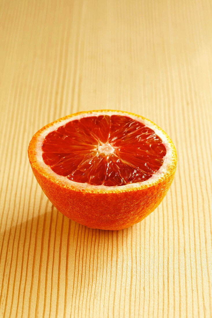 Blood orange half on light background