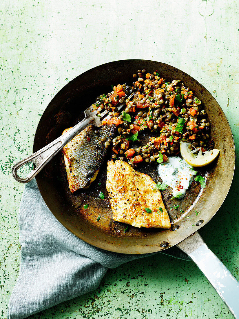 Fried seabass with lentils and tzatziki
