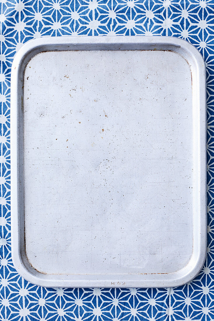 Grey tray on blue background