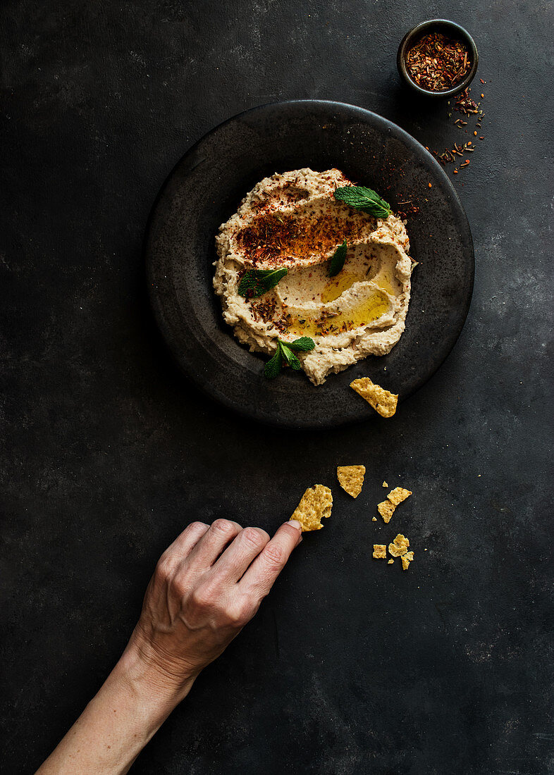 Black plate with eggplant and cauliflower dip