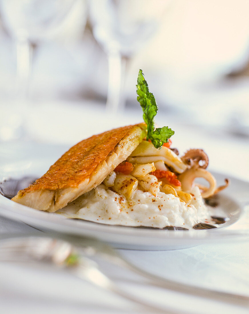 Red mullet with seafood on risotto