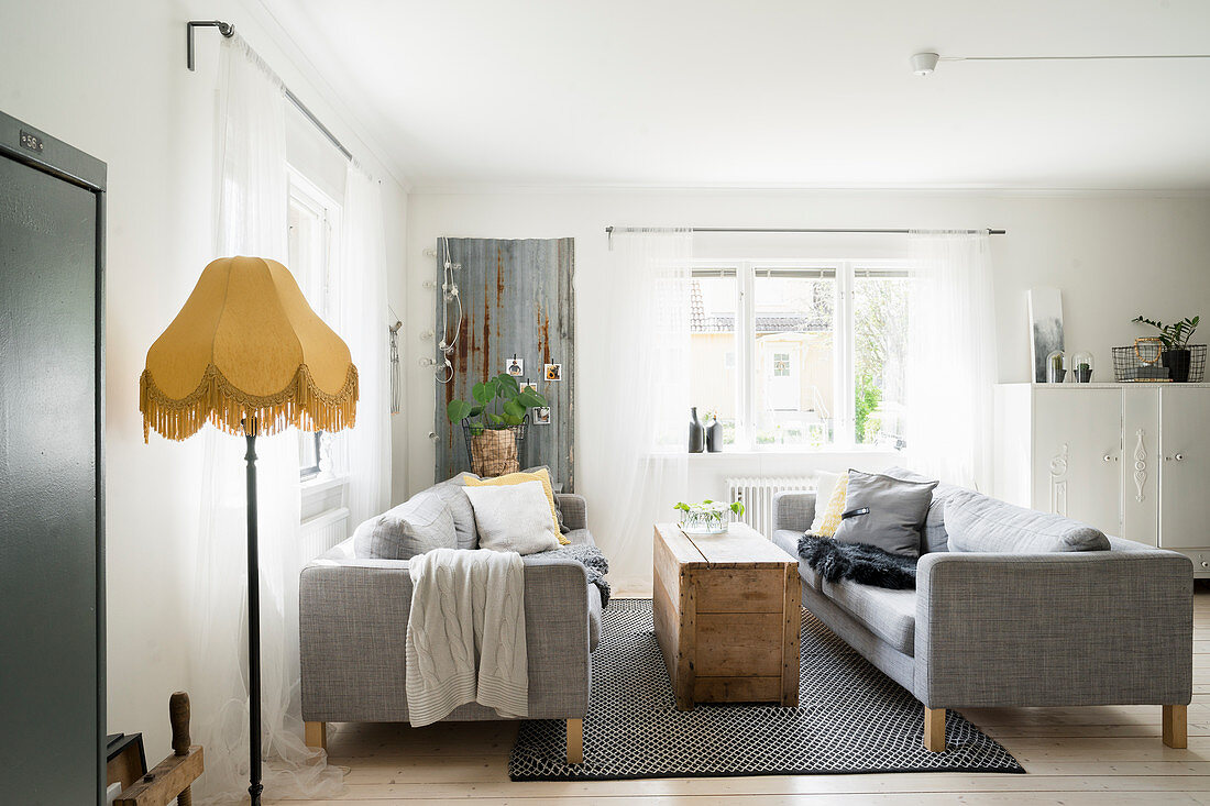 Two grey sofas facing one another in vintage-style living room