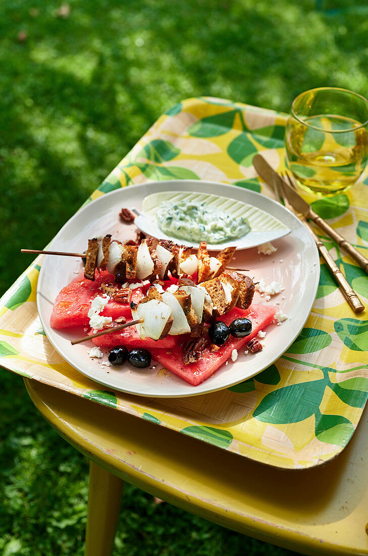 Grilled cheese and bread skewers on slices of watermelon