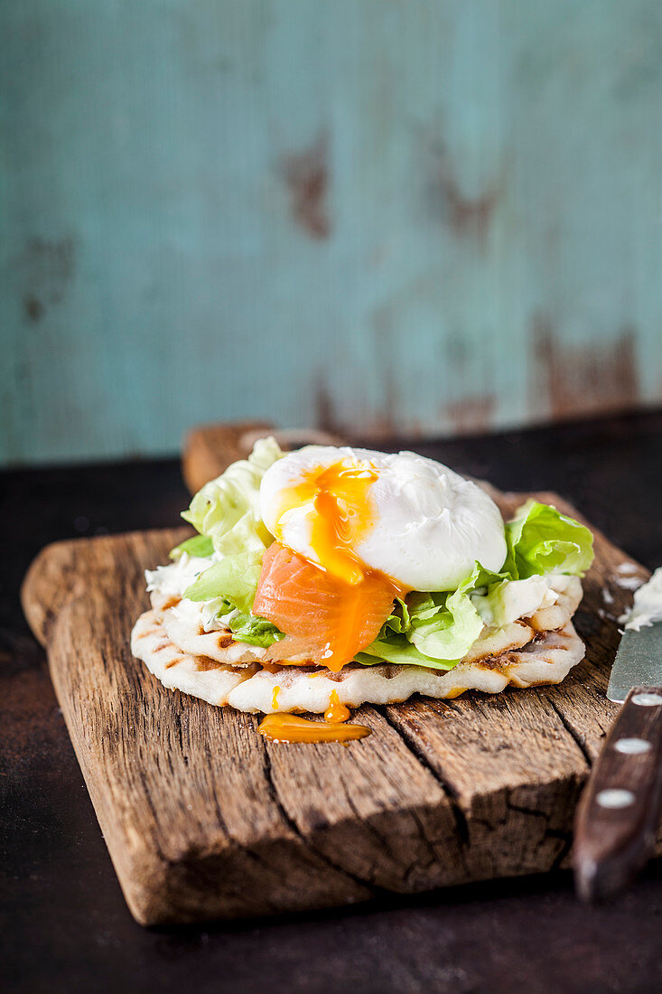 Waffle sandwich with salmon and a poached egg