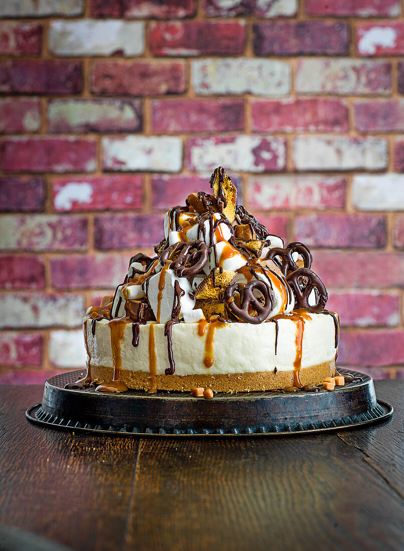 Freakshake cheesecake with marshmallows, chocolate sauce and pretzels