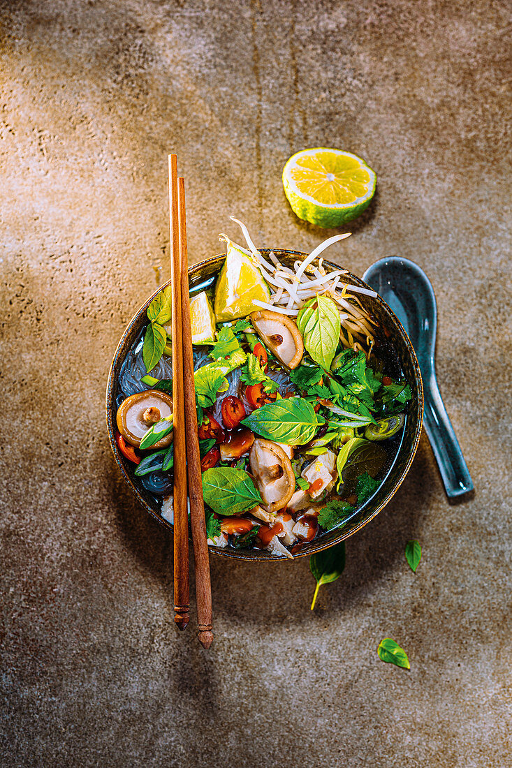 Rice noodle pho with chicken, shiitake and pak choi