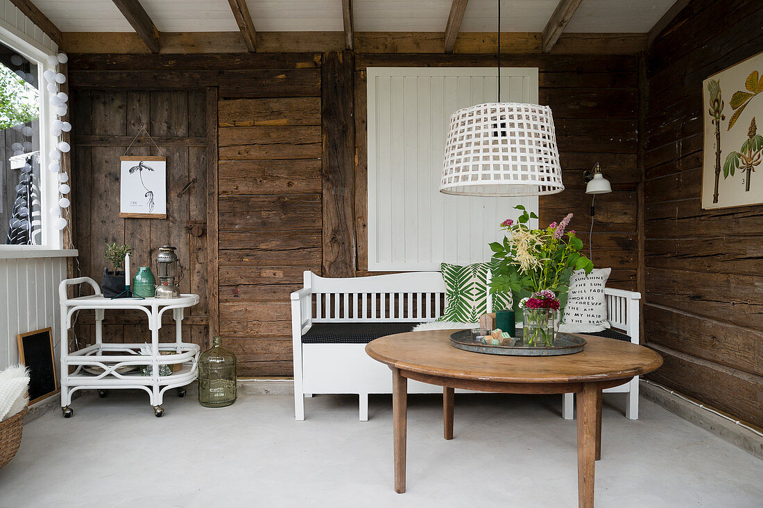 Interior of rustic summerhouse with wooden walls and white floor