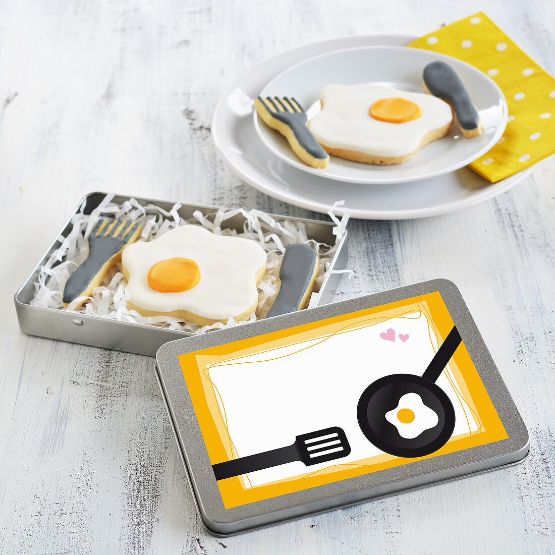 Fried egg and cutlery biscuits in a tin and on a plate