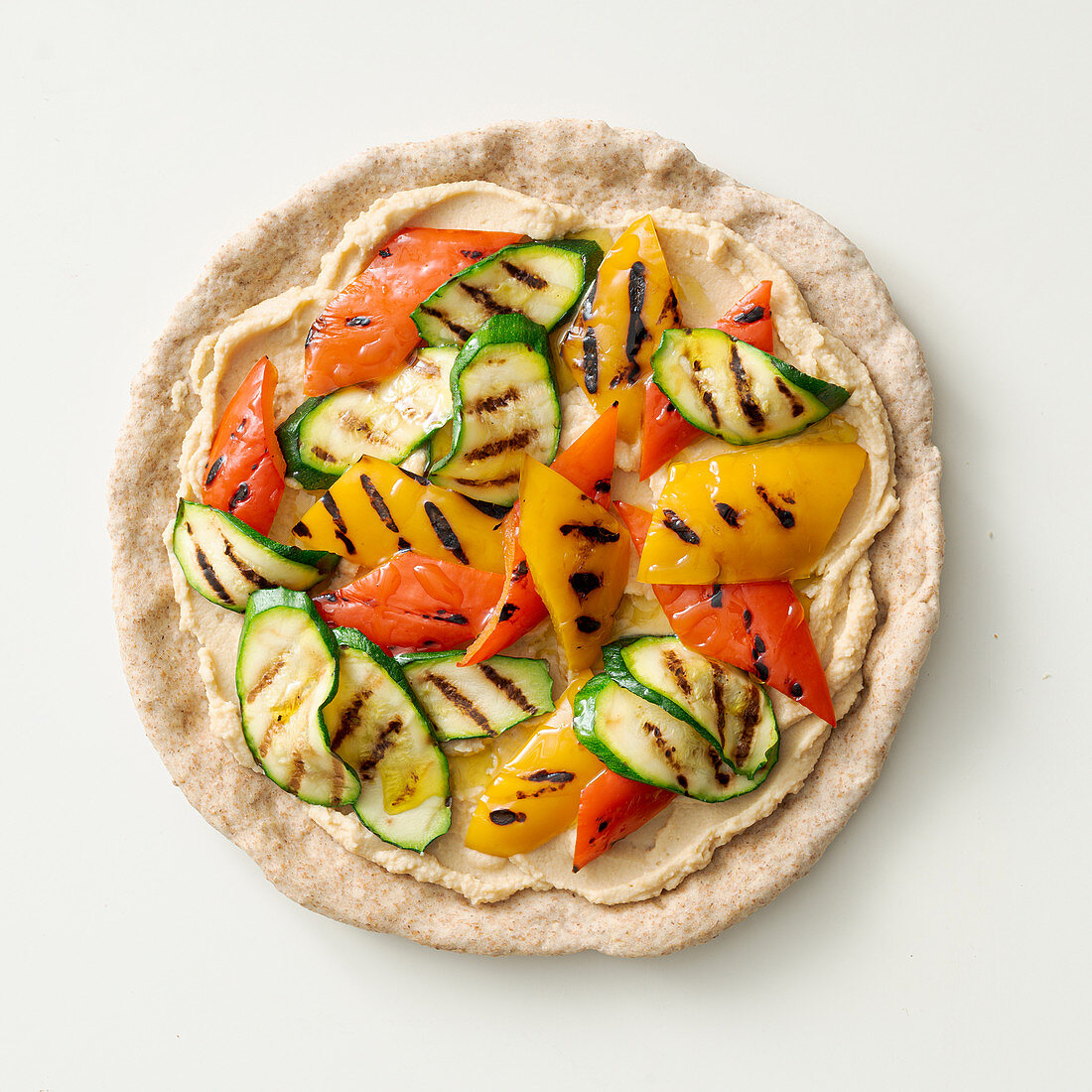 Pan pizza with hummus and grilled vegetables