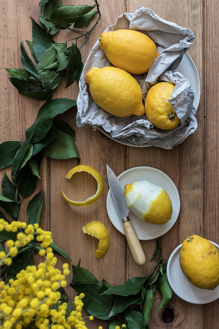 Zitronenstilleben mit Zitronenblättern und -schale