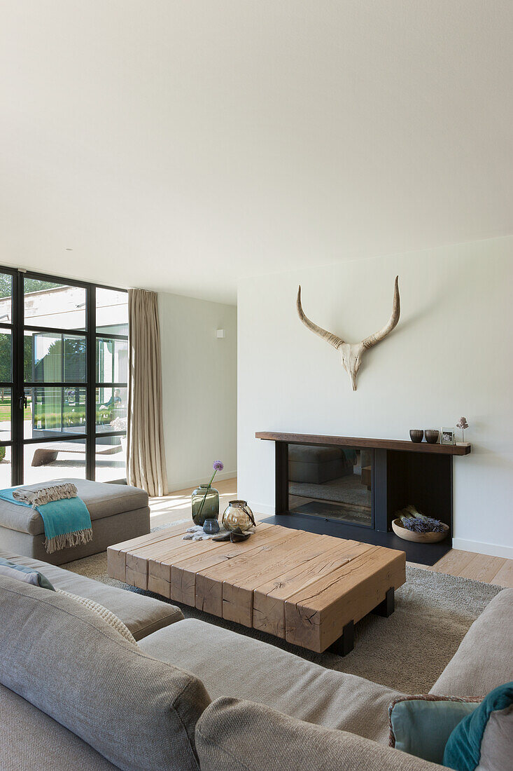 Bright living room with large wooden table and view of the terrace