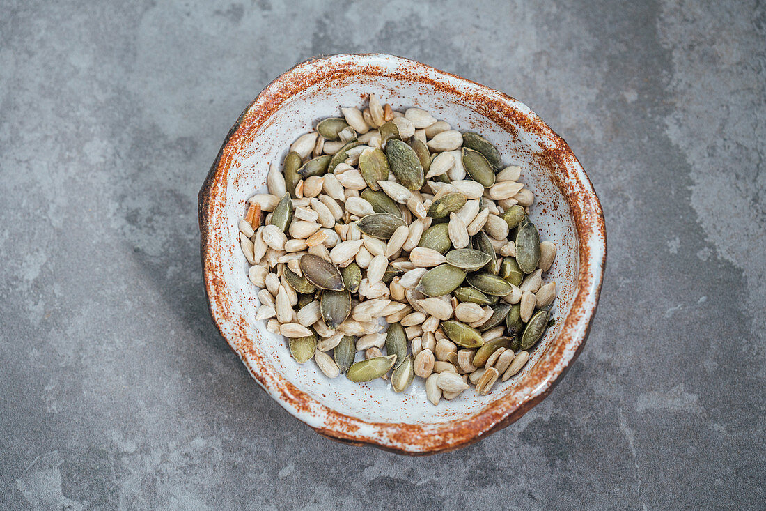 Roasted pumpkin and sunflower seeds in a hand made bowl