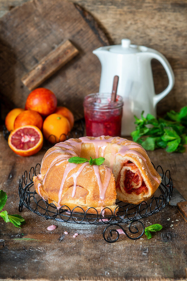 Yeast cake with blood orange jam filling and glaze