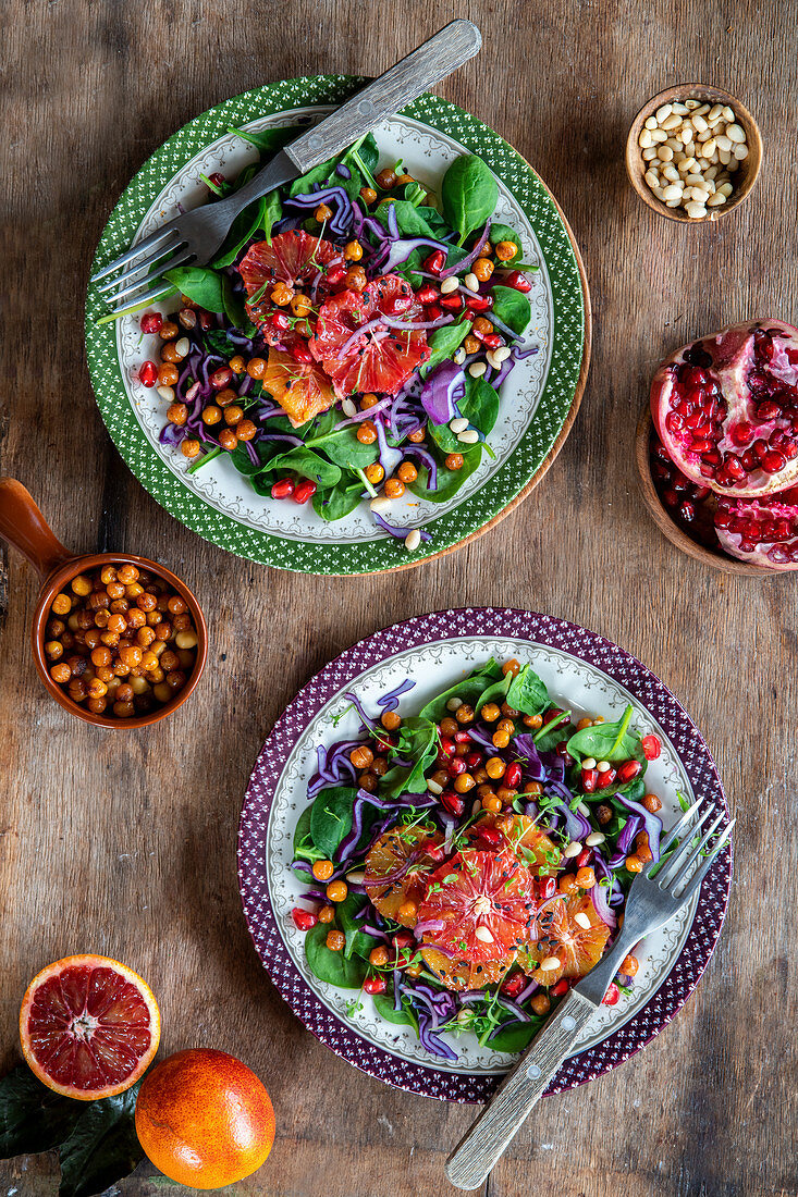 Vegetarian salad with spicy chick peas, blood orange, red cabbage and rocket salad