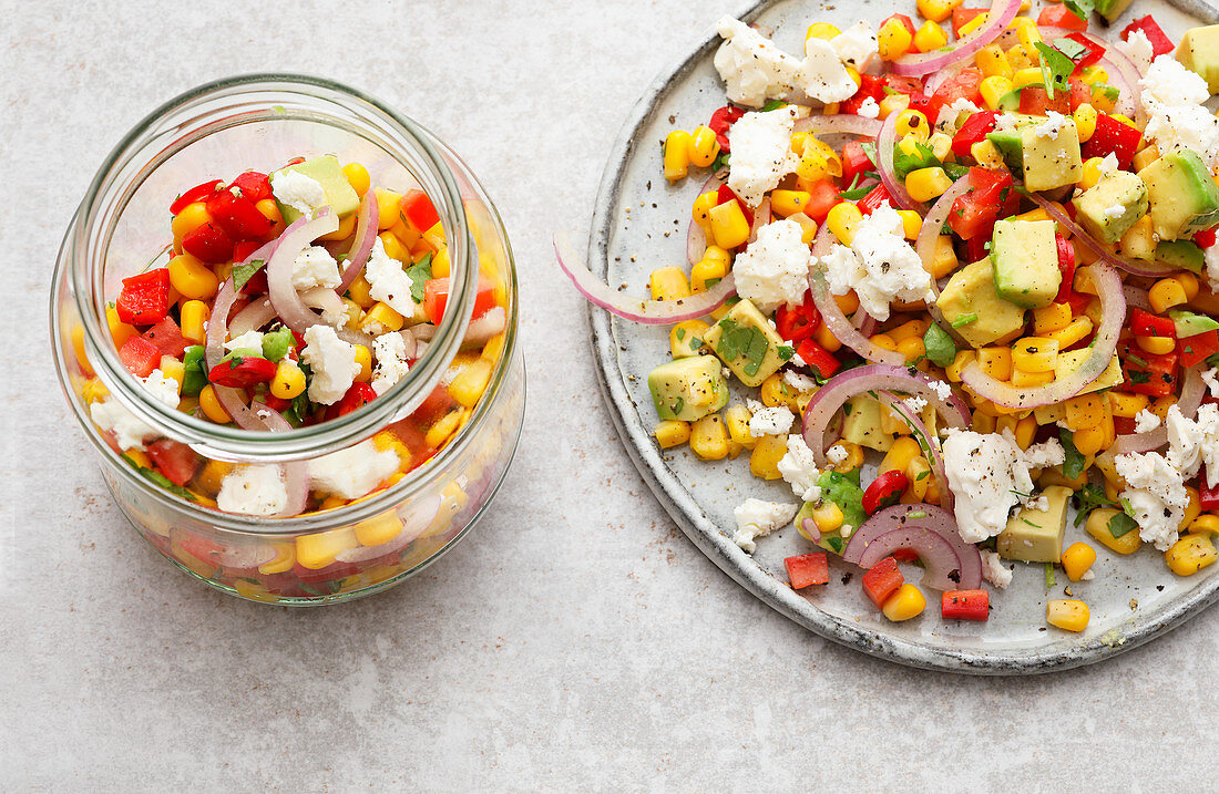 Colourful sweetcorn salad with avocado, peppers and feta cheese to take away