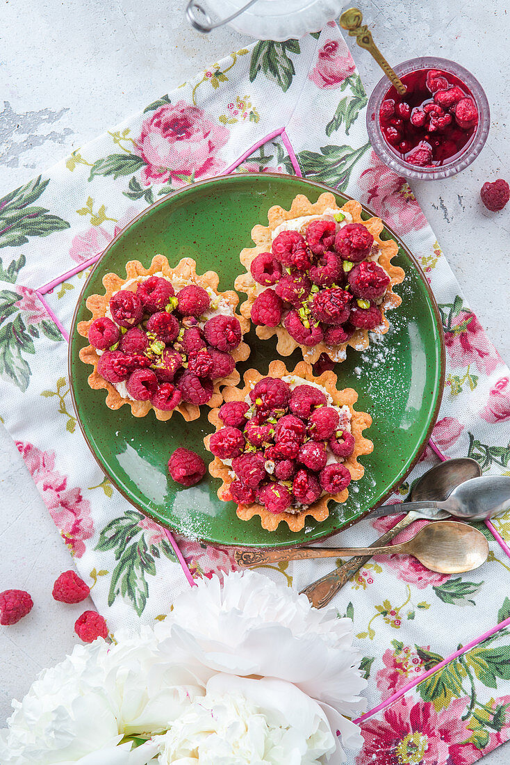 Raspberry tarts with pistachios from above