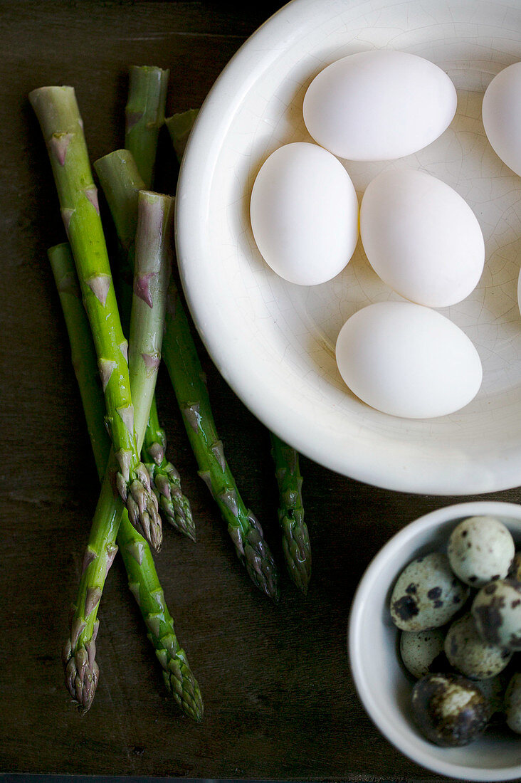 White hens eggs, quails eggs and asparagus still life