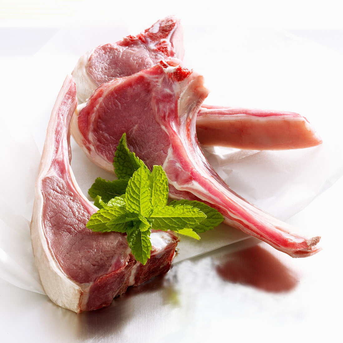 Raw lamb chops with fresh mint