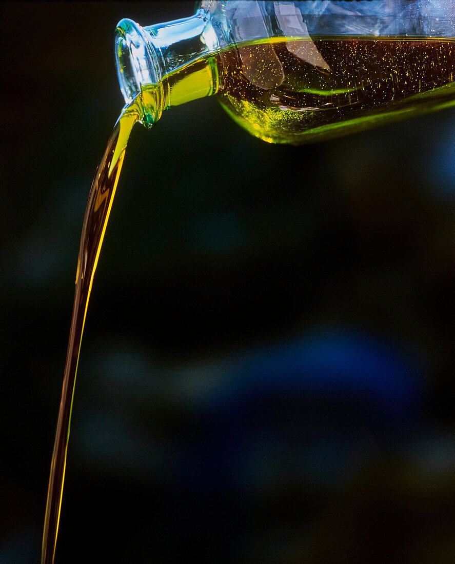 Pouring olive oil from a bottle