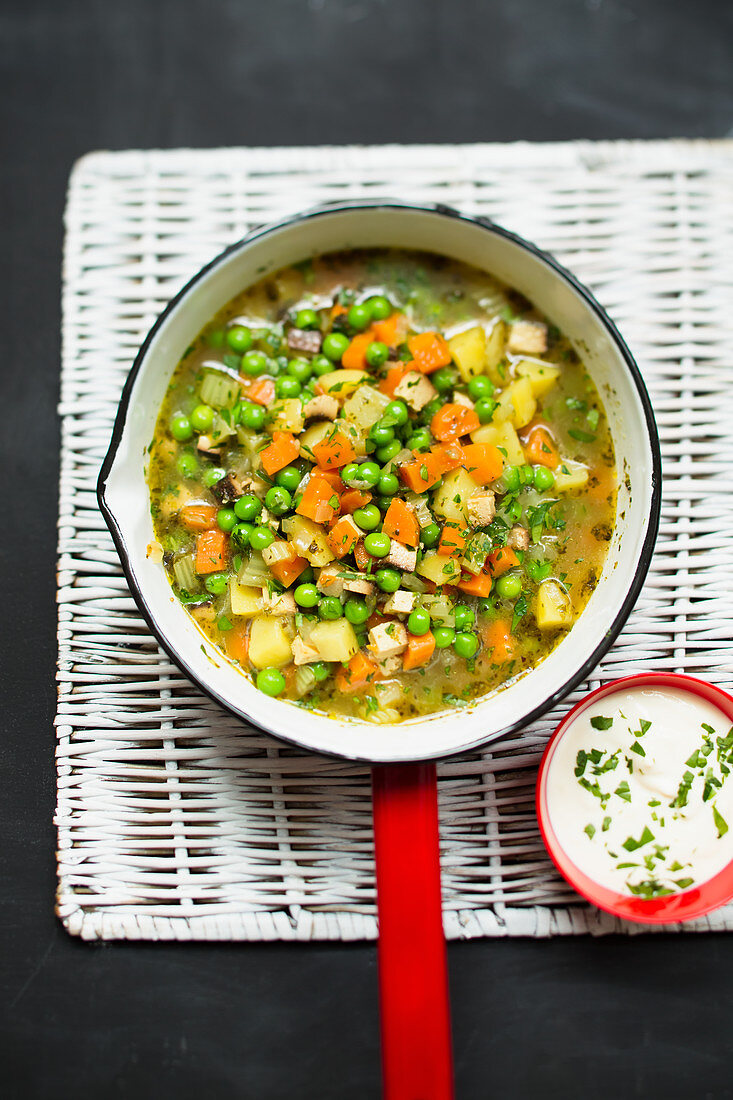 Vegan vegetable soup with peas and smoked tofu