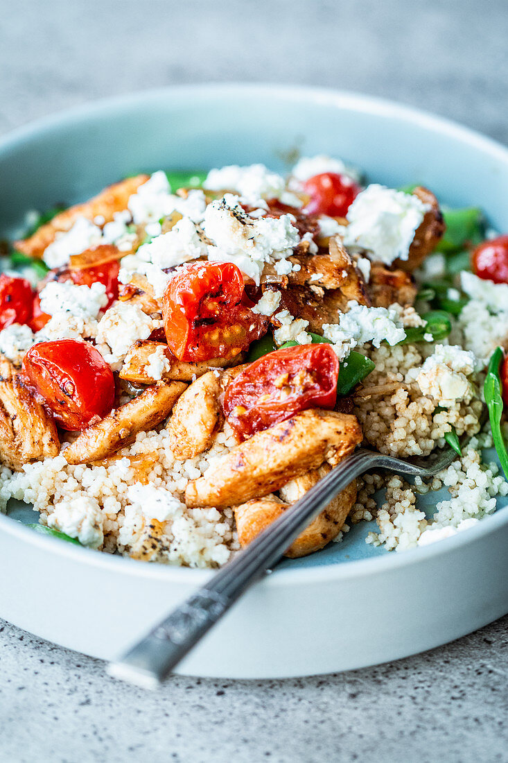 Couscous salad with chicken, braised tomatoes and feta