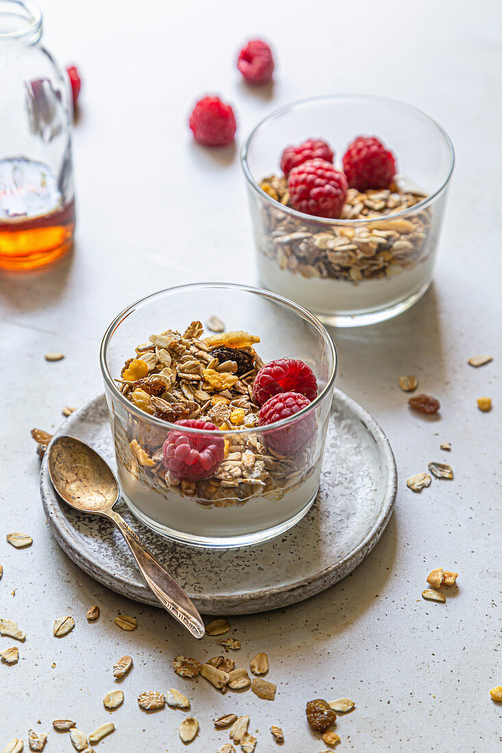 Healthy breakfast, coconut yoghurt, served with homemade muesli and fresh rasberries