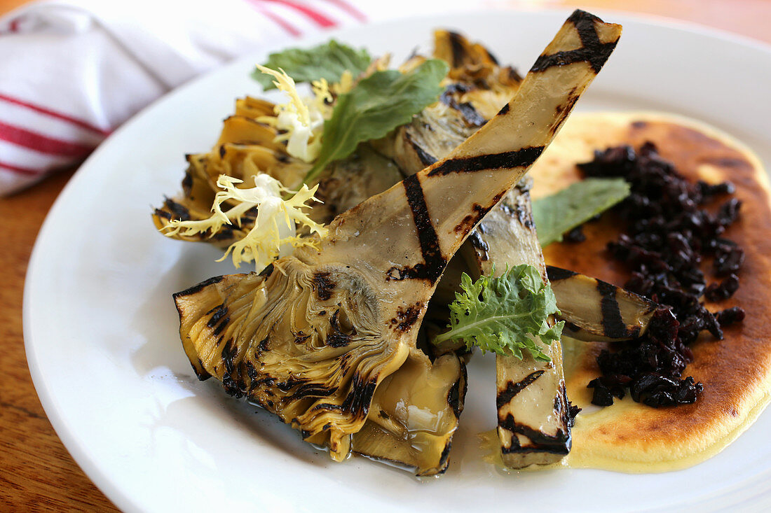 Grilled baby artichokes with black olive crumbs and zabaglione sauce