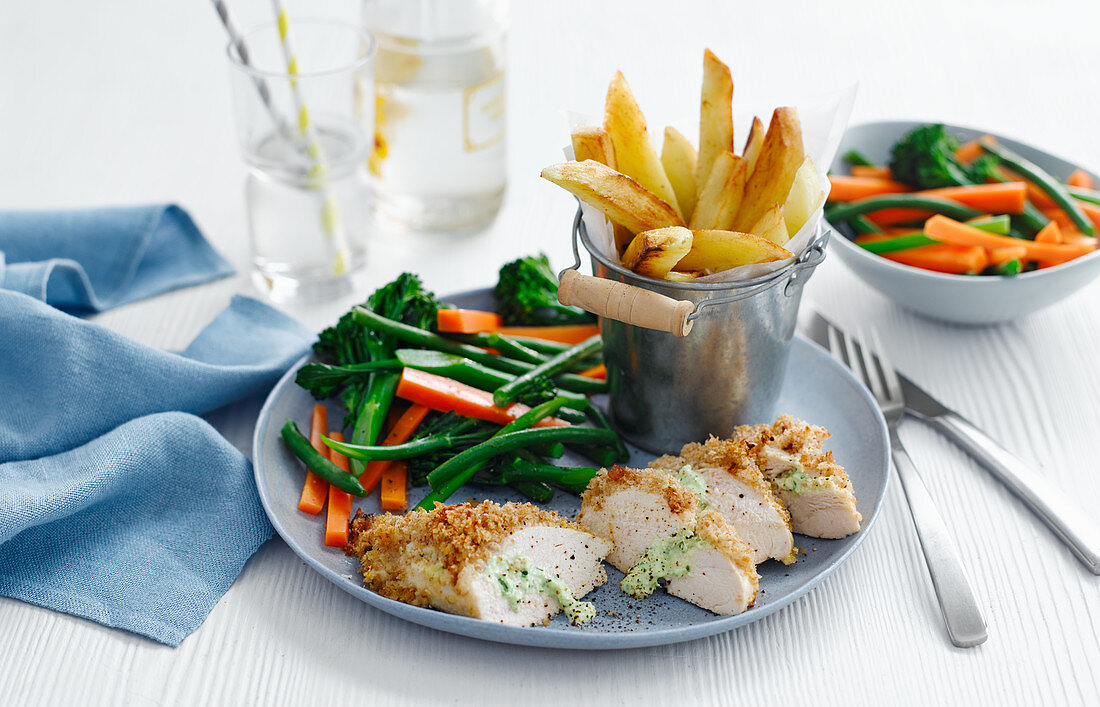 Chicken Kiev with vegetables and french fries