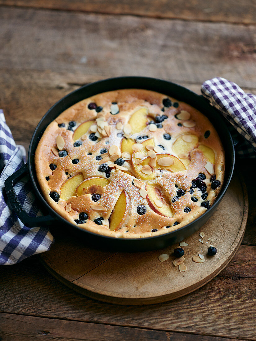 Blueberry and peach pancake bake with flaked almonds