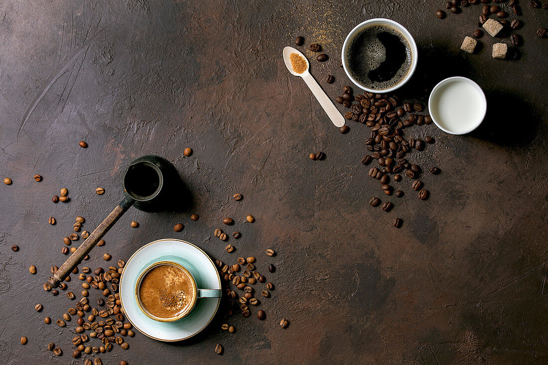 Variety of paper cups of americano coffee and milk versus turkish coffee in ceramic cup and cezve