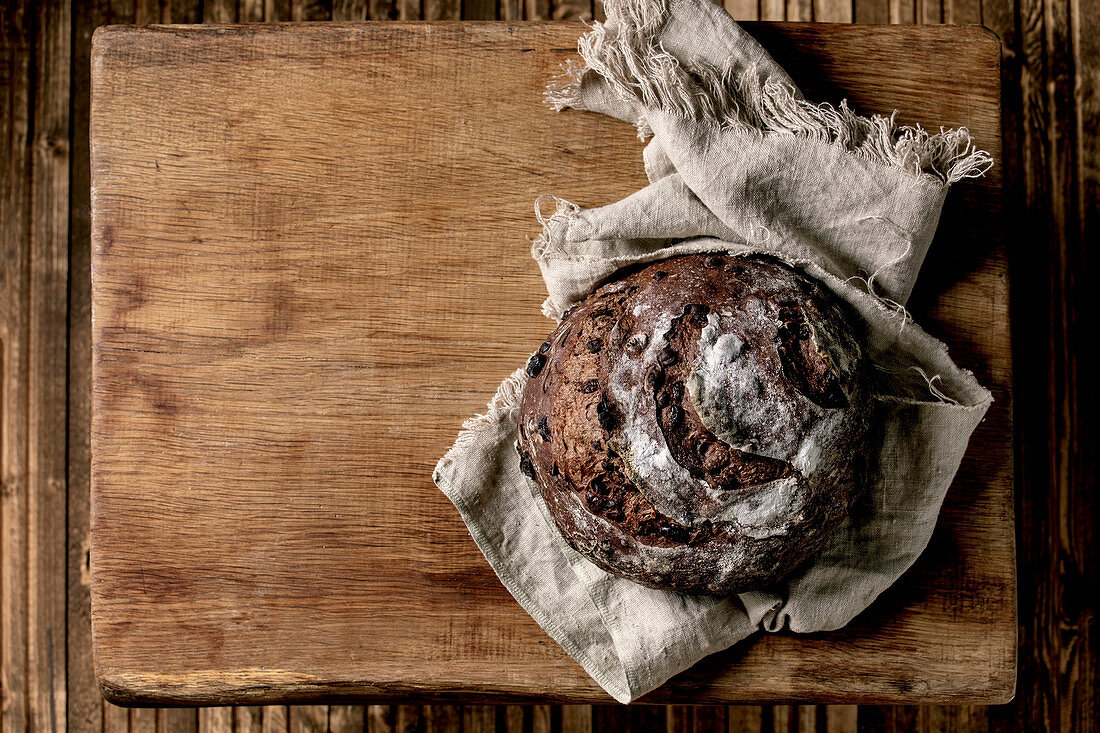 Whole fresh baked artisan round homemade chocolate and cranberries rye bread