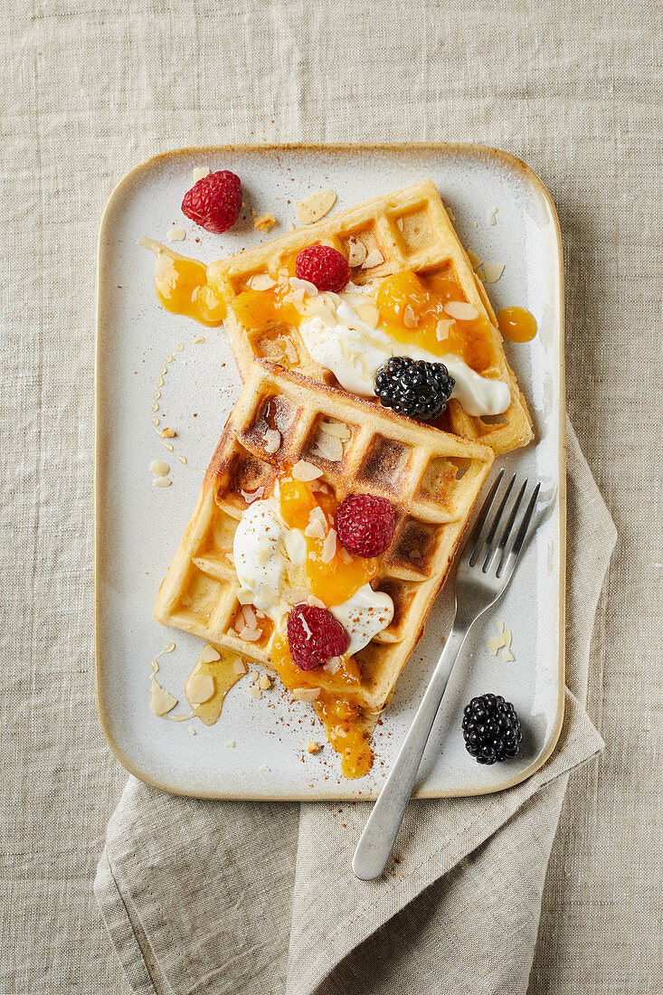 Belgian waffles with yogurt, apricot puree, flaked almonds, honey, blackberries and raspberries