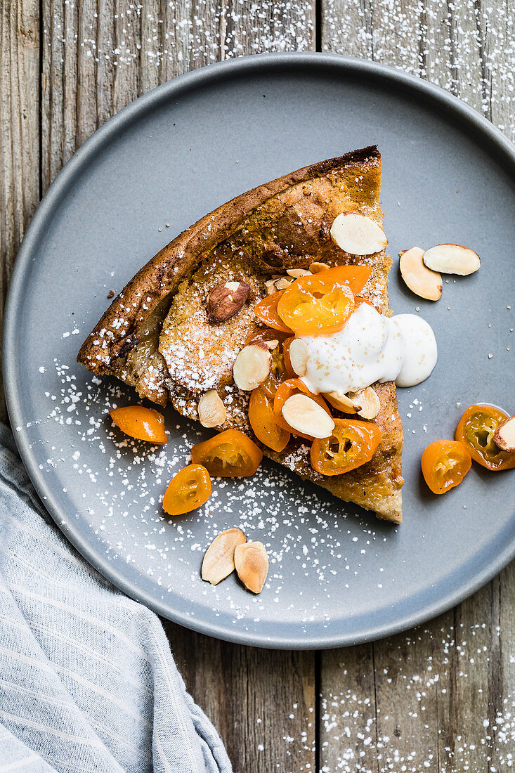 Cinnamon spiced almond dutch baby with honeyed kumquats, and a dollop of vanilla bean crème fraîche