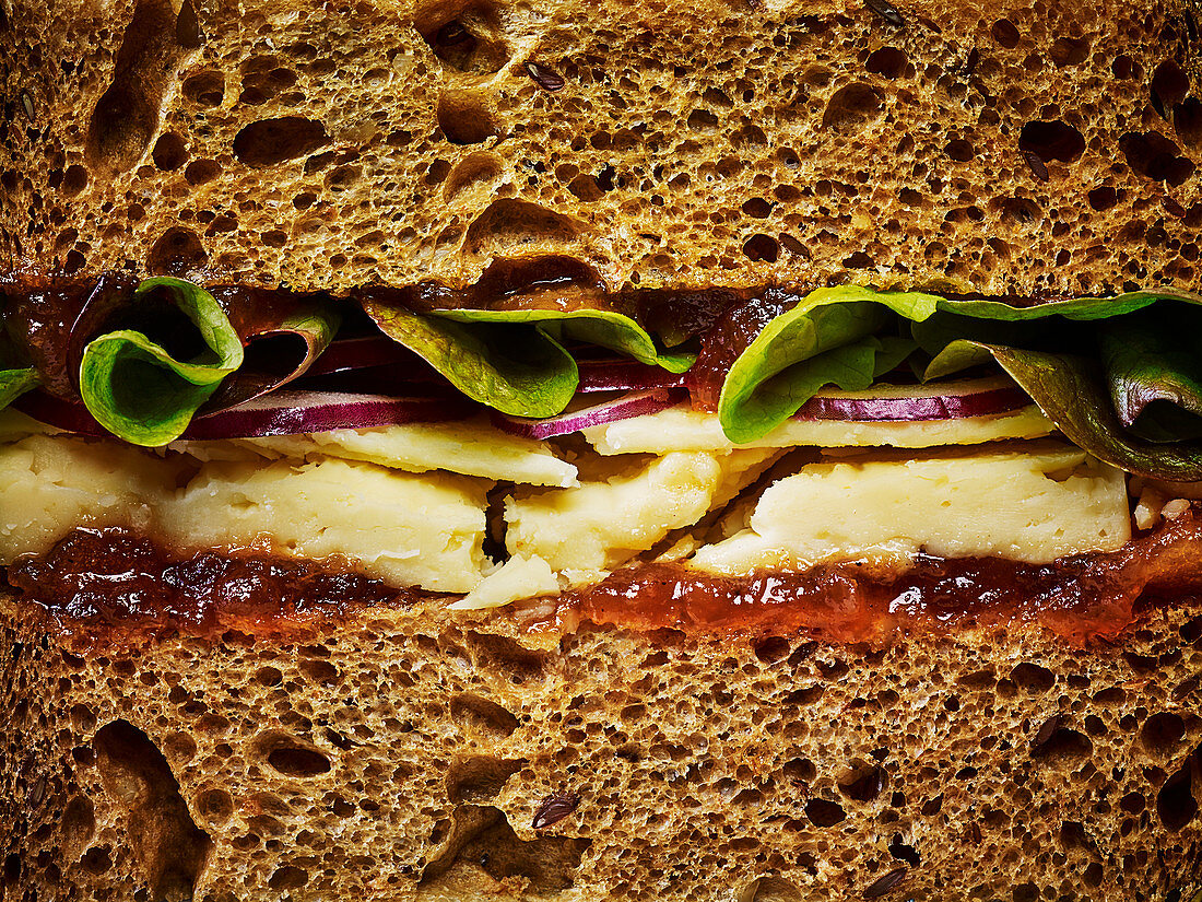 A ploughmans cheese sandwich on bown bread, close up