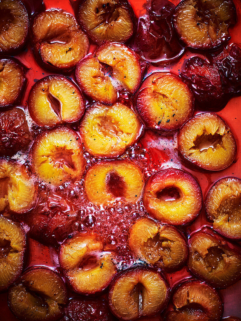 Roasted plums in a baking tray