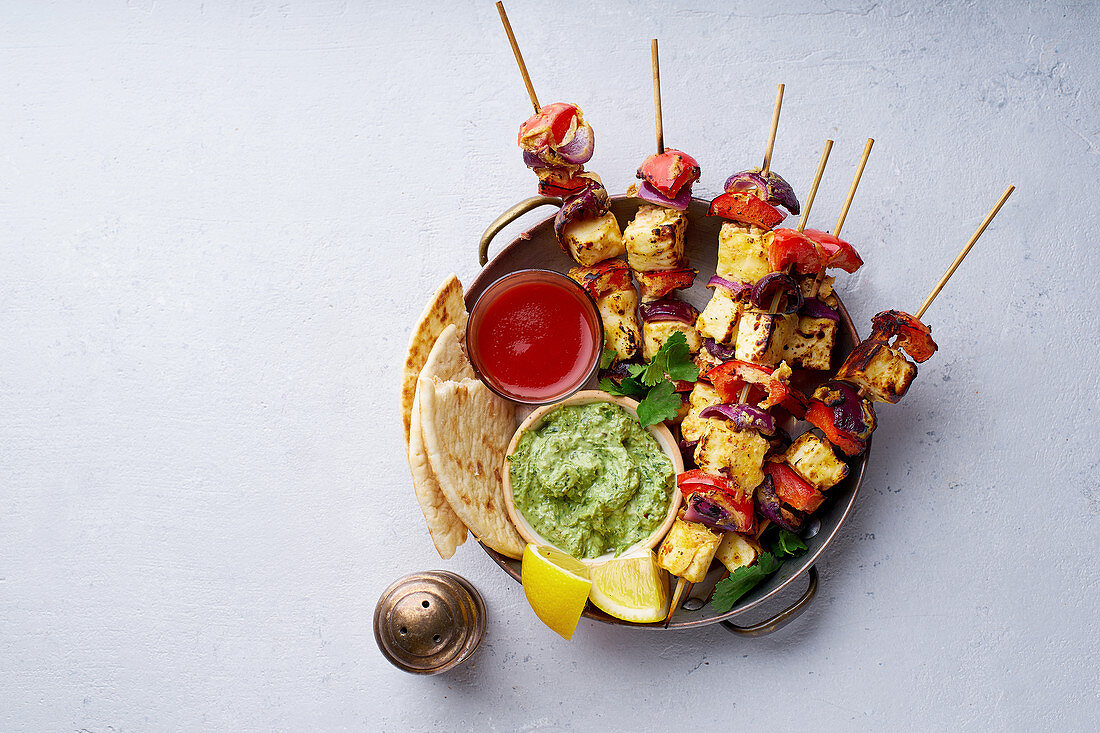 Grilled onion and pepper paneer skewers with, flatbread, chilli and peppermint sauce