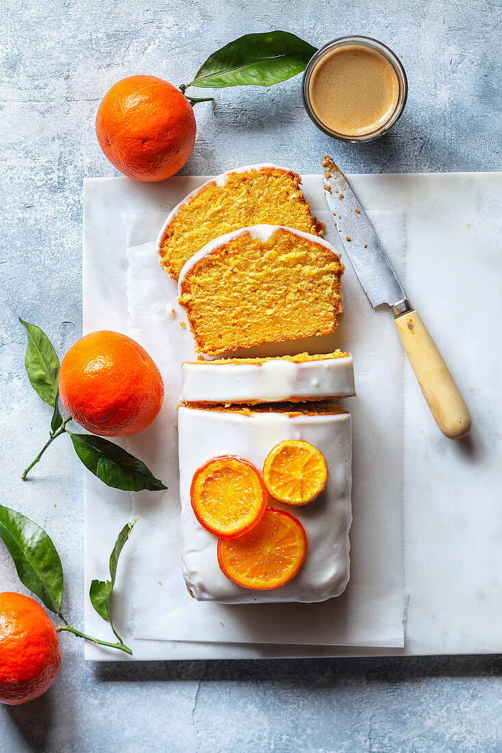 Sliced clementine pound cake and a cup of coffee on the table