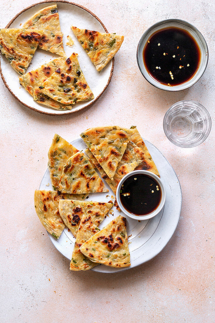 Chinese scallion pancakes on the plate served with chilli soy sauce