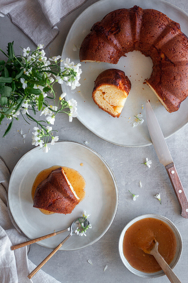 Top view of delicious Bundt cake with apple sauce placed on table