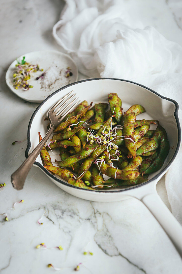 Bowl with edamame dish on table