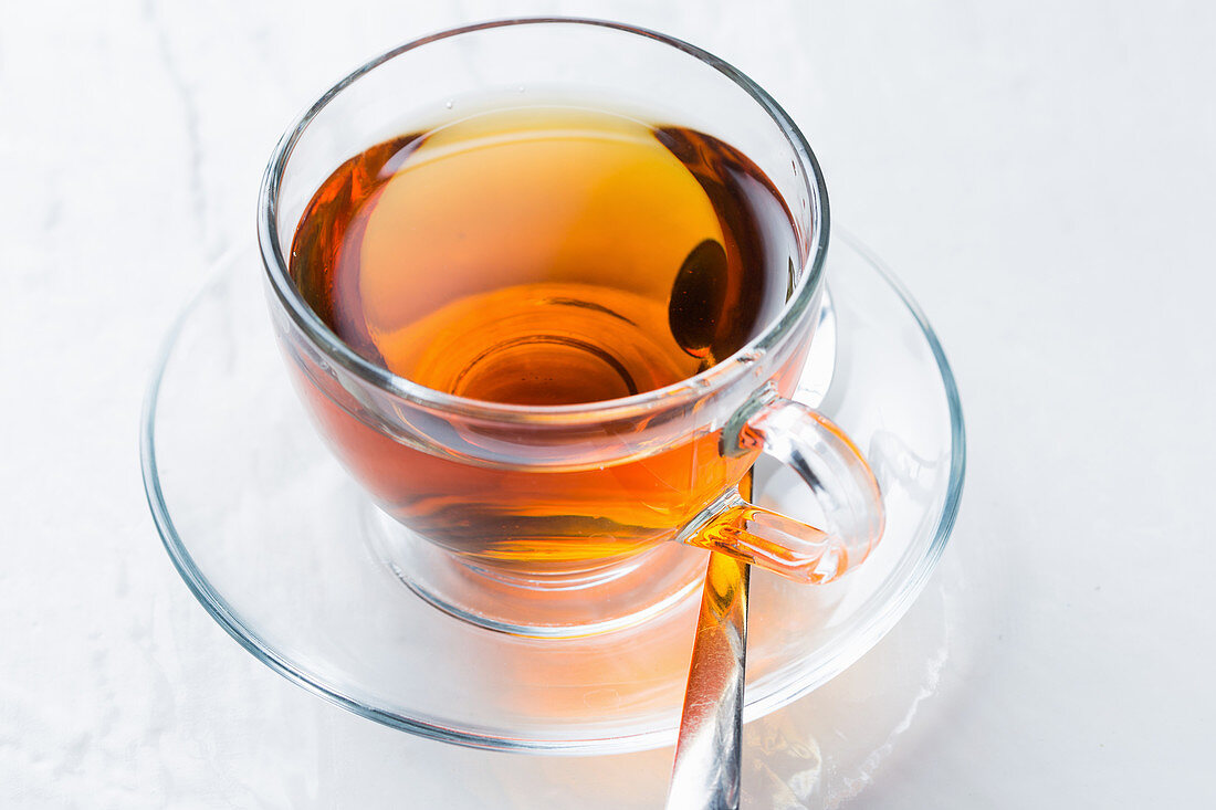 Glass cup of aromatic hot tea