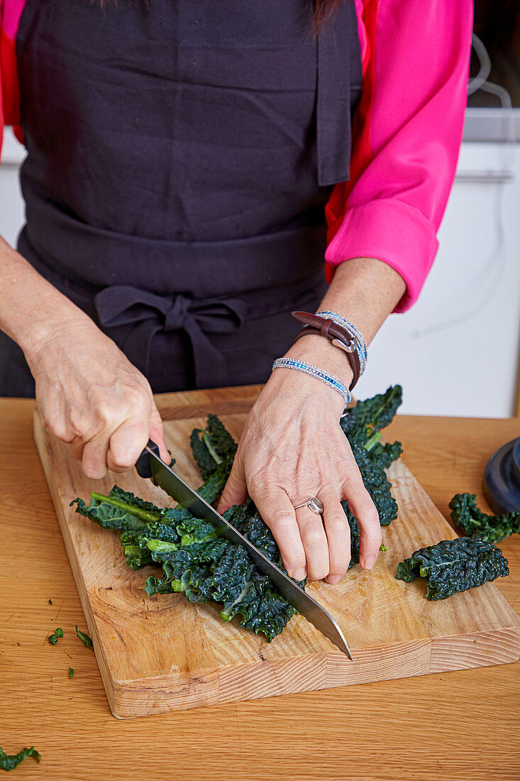 Woman cutting fresh kale