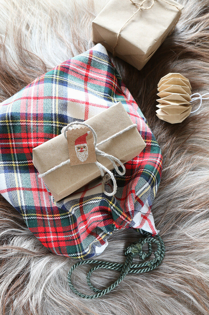 Tartan sachet and wrapped gifts on fur rug