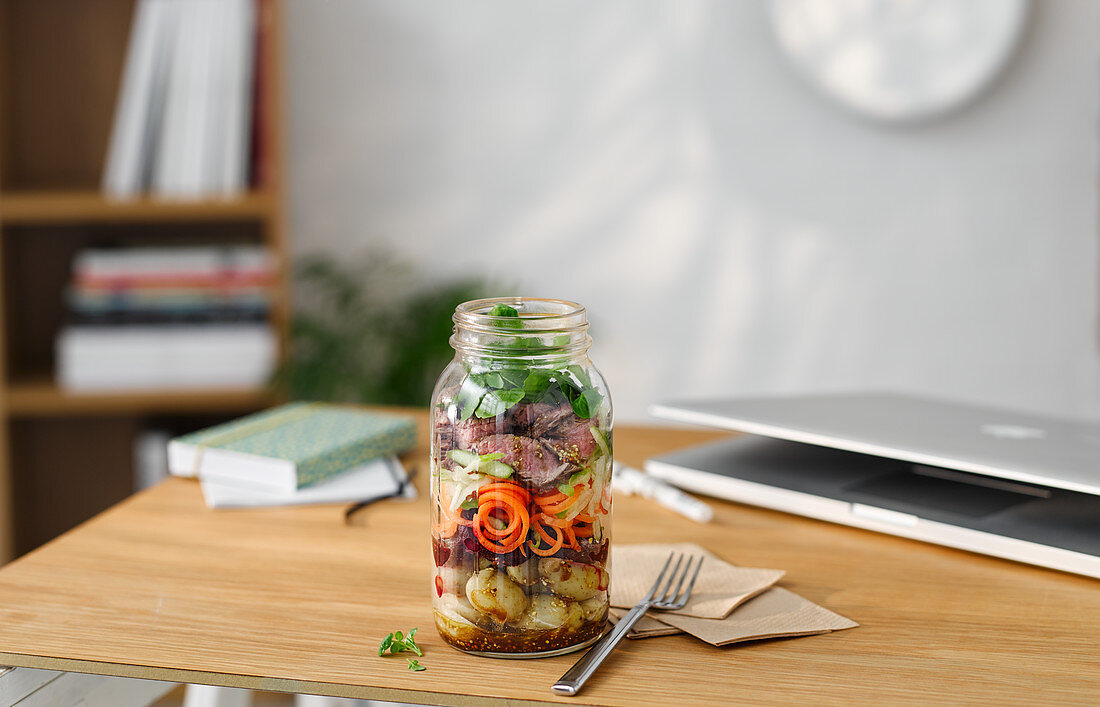 Lunch in a glass jar with steak, potatoes and vegetables